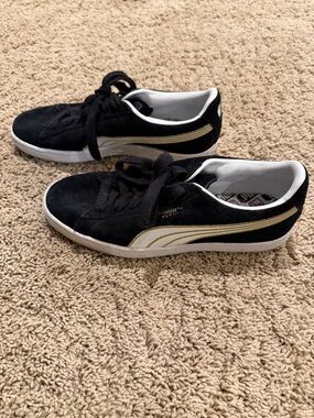 Puma black and gold shoes